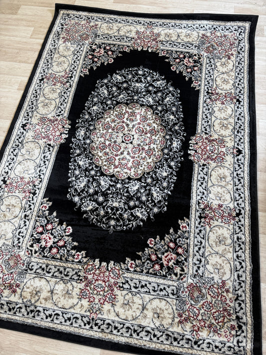 Decorative rug with intricate patterns on a wooden floor